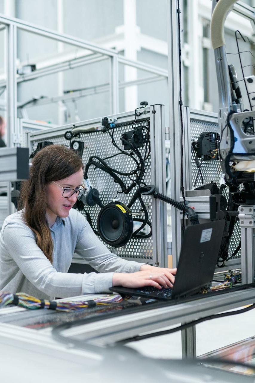 woman in white long sleeve shirt using black laptop computer